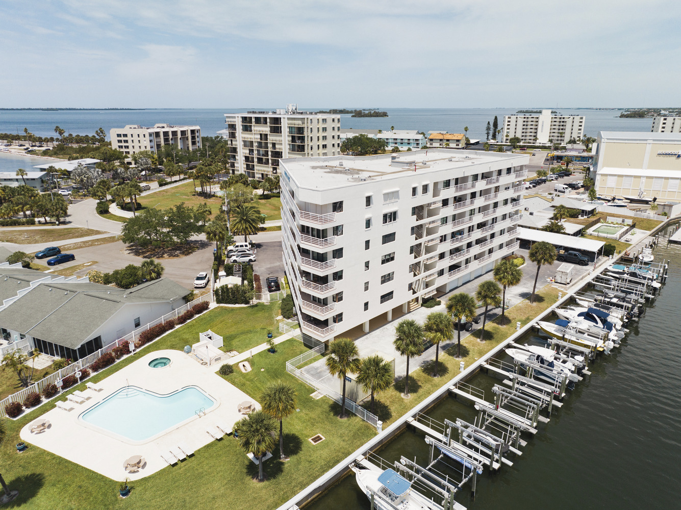 marina-place-3 Marina Place condo seen from above, with swimming pool, palm trees, and harbor full of boats in the foreground